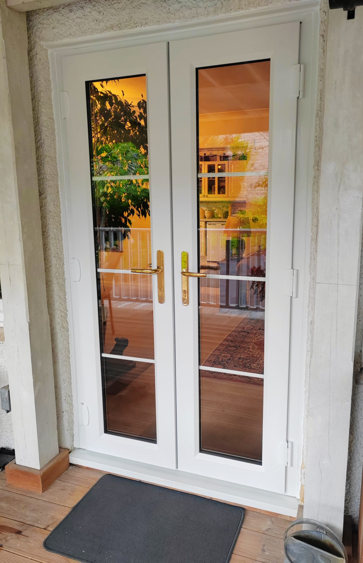 White UPVC french doors with georgian bars and gold handles